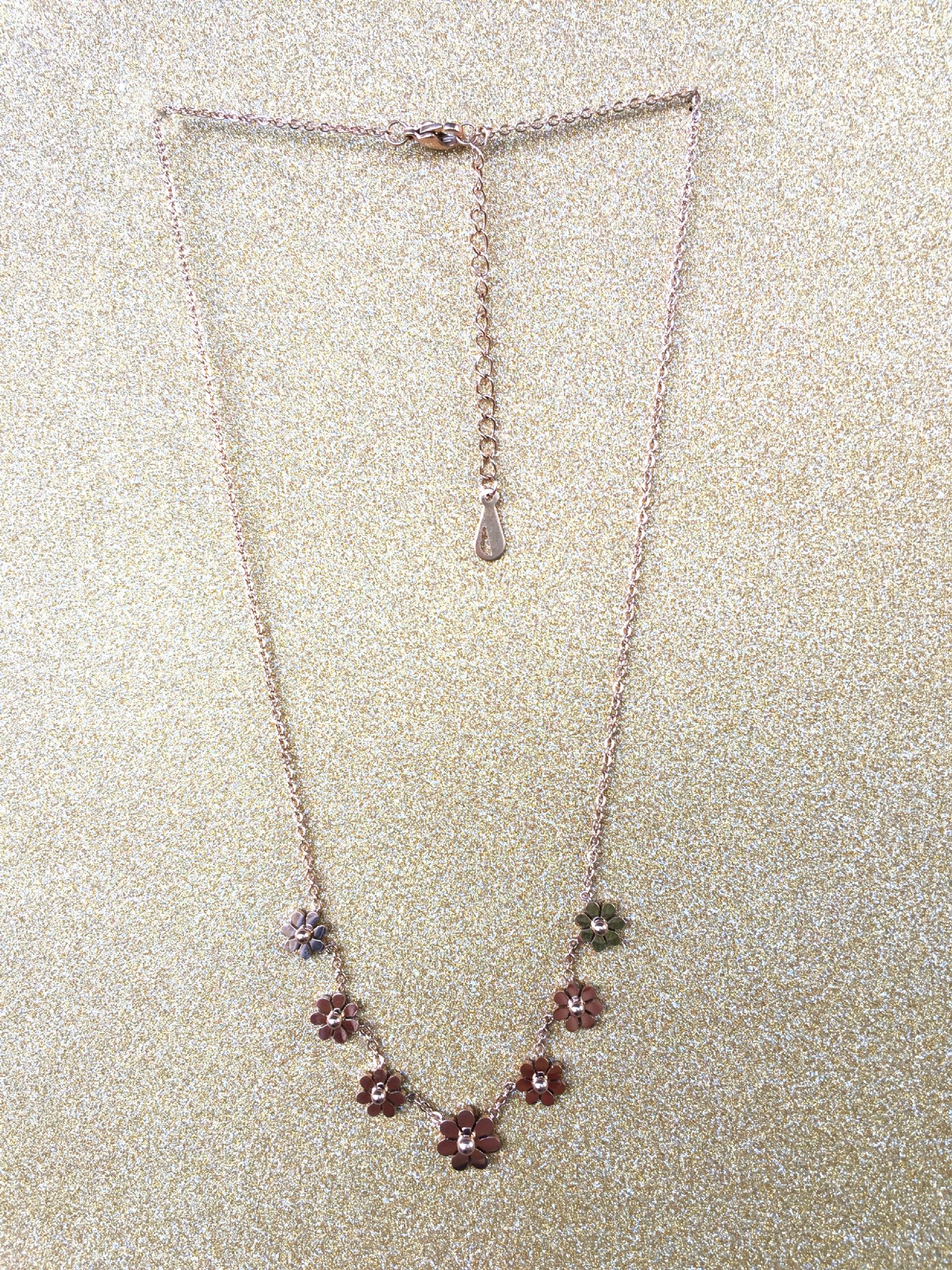 A beautiful butterfly pendant made of mother of pearl and emblazoned with small glittering crystals on a gold metal base. J020010